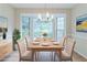 Bright dining room featuring large windows, modern chandelier and hardwood floors at 10 Mariner Se Way, Acworth, GA 30102