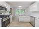Modern kitchen boasts stainless steel appliances, white cabinets, and lots of natural light at 10 Mariner Se Way, Acworth, GA 30102