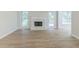 Bright living room features a white brick fireplace, hardwood floors, and access to outdoor deck at 10 Mariner Se Way, Acworth, GA 30102