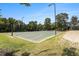 Community basketball court surrounded by lush green grass and trees, with basketball hoops and nets at 122 Susobell Pl, Woodstock, GA 30188