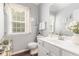 Bright bathroom with a large mirror, vanity with a white sink, and lovely decor at 122 Susobell Pl, Woodstock, GA 30188