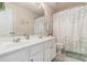Bathroom with double sinks, a large mirror, and a shower curtain with a tranquil pattern at 122 Susobell Pl, Woodstock, GA 30188