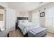 Comfortable bedroom featuring light wood floors, and a decorative macrame wall hanging above the bed at 122 Susobell Pl, Woodstock, GA 30188