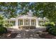 Community clubhouse entrance with American flag, seating, and manicured landscaping at 122 Susobell Pl, Woodstock, GA 30188