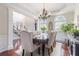 Elegant dining room with hardwood floors, chandelier, views of foyer, and dining table set for six at 122 Susobell Pl, Woodstock, GA 30188