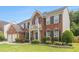 Charming two-story brick house with well-maintained landscaping, black shutters, and light trim at 122 Susobell Pl, Woodstock, GA 30188