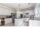 Kitchen with white cabinetry, stainless steel appliances, granite countertops and center island with seating at 122 Susobell Pl, Woodstock, GA 30188