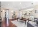 Open-concept living room with hardwood floors, neutral decor, and flow into adjacent spaces at 122 Susobell Pl, Woodstock, GA 30188