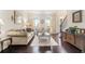 Inviting living room featuring hardwood floors, neutral paint, stylish decor, and ample seating at 122 Susobell Pl, Woodstock, GA 30188