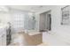 Bathroom featuring a glass shower, soaking tub, and a double sink vanity with excellent lighting at 122 Susobell Pl, Woodstock, GA 30188