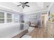 Primary bedroom with lots of natural light, a ceiling fan, neutral paint, and tray ceilings at 122 Susobell Pl, Woodstock, GA 30188