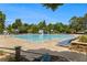 Large community pool with lounge chairs, slides, and lush landscaping for residents' enjoyment at 122 Susobell Pl, Woodstock, GA 30188
