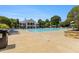 Expansive community pool with ample lounge chairs, lifeguard station, and nearby clubhouse at 122 Susobell Pl, Woodstock, GA 30188