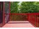Open back porch with wood flooring and railing, offering a serene view of the lush greenery at 2850 Seagrave Way, Marietta, GA 30066