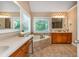 Bright bathroom with double vanities, soaking tub, granite countertops, and two large mirrors at 2850 Seagrave Way, Marietta, GA 30066