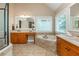 Bathroom with double vanities, a soaking tub, granite countertops, and a walk-in shower at 2850 Seagrave Way, Marietta, GA 30066