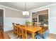 Elegant dining room featuring wainscoting, a wood table, and views into the office at 2850 Seagrave Way, Marietta, GA 30066