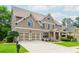 Traditional home with a two-car garage, well-kept lawn, and inviting covered front porch at 2850 Seagrave Way, Marietta, GA 30066