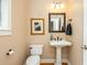 Well-lit half bathroom with modern fixtures including a pedestal sink and toilet at 2850 Seagrave Way, Marietta, GA 30066