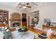 Inviting living room features a stone fireplace, built-in cabinets, and hardwood floors with views of the stairway at 2850 Seagrave Way, Marietta, GA 30066