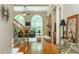 An open-concept living room features hardwood floors, a stone fireplace, large arched windows, and staircase in view at 2850 Seagrave Way, Marietta, GA 30066