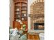 Cozy living room featuring a stone fireplace, built-in bookshelves, and comfortable seating, perfect for relaxing evenings at 2850 Seagrave Way, Marietta, GA 30066
