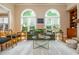Bright living room showcasing arched windows, hardwood floors, a stone fireplace, and stylish seating arrangements at 2850 Seagrave Way, Marietta, GA 30066
