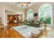 Bright living room featuring hardwood floors, high ceilings, large windows, and an open floor plan connecting to the kitchen at 2850 Seagrave Way, Marietta, GA 30066