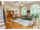 Spacious living room featuring hardwood floors, fireplace, large windows, and a view of the kitchen and dining area at 2850 Seagrave Way, Marietta, GA 30066