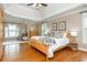 Bright main bedroom with a tray ceiling, hardwood floors, ceiling fan, and plenty of natural light at 2850 Seagrave Way, Marietta, GA 30066