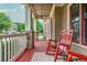 Inviting front porch with a red rocking chair, stone accents, and painted floors at 2850 Seagrave Way, Marietta, GA 30066