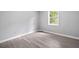 Bedroom with a large window, new light wood floor and neutral gray walls at 3232 Valley View St, Powder Springs, GA 30127