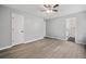 Spacious bedroom showcasing multiple doors, new light wood floors, and grey walls at 3232 Valley View St, Powder Springs, GA 30127