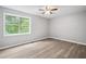 Bright bedroom with ceiling fan, modern ceiling fan, and new light wood floor at 3232 Valley View St, Powder Springs, GA 30127