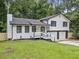 Charming home featuring fresh white siding, a black roof, and well-manicured landscaping at 3232 Valley View St, Powder Springs, GA 30127