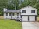 Inviting home with white siding, black accents, and a convenient two-car garage at 3232 Valley View St, Powder Springs, GA 30127