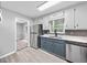Kitchen showcasing stainless steel refrigerator, stone countertops, and two-tone cabinets at 3232 Valley View St, Powder Springs, GA 30127