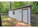 A view of a shed with a single window and door in the backyard at 3232 Valley View St, Powder Springs, GA 30127