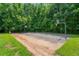 Outdoor community basketball court surrounded by mature trees for recreation and fitness at 390 Glengarry Chase, Covington, GA 30014