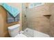Bathroom with a glass-enclosed shower, neutral tile, and a low-flow toilet for an efficient design at 390 Glengarry Chase, Covington, GA 30014