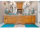 Bathroom with custom cabinets, granite countertops, dual sinks, and decorative mirrors and lighting at 390 Glengarry Chase, Covington, GA 30014