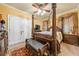 This traditional bedroom features a four-poster bed and dark wood furniture, with carpet and curtains at 390 Glengarry Chase, Covington, GA 30014