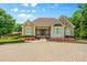Well-maintained clubhouse with brick-paved parking and colorful flower beds at 390 Glengarry Chase, Covington, GA 30014