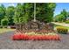 A decorative stone entrance to the community center surrounded by flower beds at 390 Glengarry Chase, Covington, GA 30014