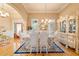 Formal dining room with chandelier, hardwood floors, and elegant decor at 390 Glengarry Chase, Covington, GA 30014
