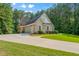 Brick home with an attached three car garage, a long driveway, and an expansive lawn at 390 Glengarry Chase, Covington, GA 30014