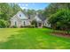 Beautiful two-story brick home featuring a well-manicured lawn and mature landscaping at 390 Glengarry Chase, Covington, GA 30014