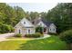 Charming brick home features a well-manicured lawn and mature trees at 390 Glengarry Chase, Covington, GA 30014