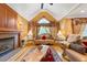 Sophisticated living room with a fireplace, lots of light from windows, and hardwood floors at 390 Glengarry Chase, Covington, GA 30014