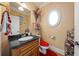 Stylish powder room with dark countertops, a vessel sink, and unique décor, offering a luxurious touch at 390 Glengarry Chase, Covington, GA 30014